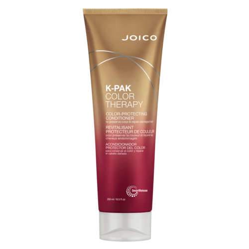 A brown and pink tube of Joico K-Pak Color Therapy conditioner for protecting and repairing color-treated hair.