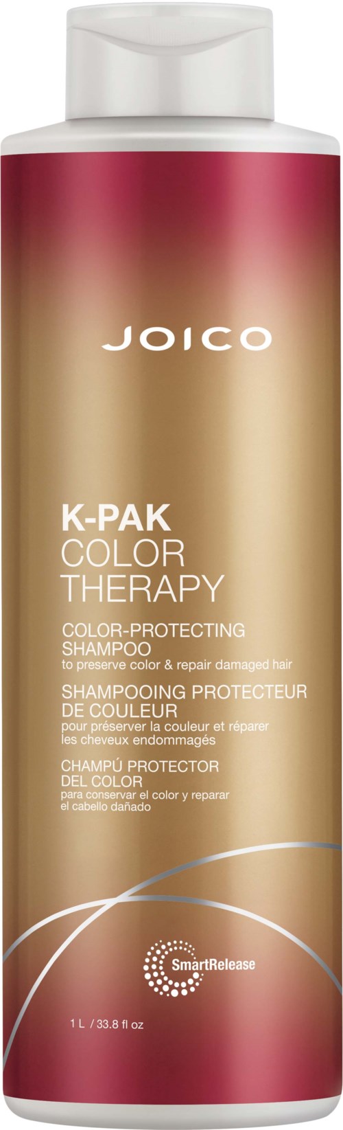 Pitkä, sylinterimäinen shampoo-pullo, jossa valkoinen kansi, vaaleanpunainen ja beige sävyinen liukuvärjäys ja Joico-merkki.