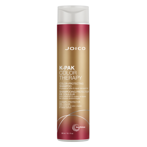 A tall, cylindrical bottle of Joico K-Pak Color Therapy shampoo with a white cap and reddish-brown gradient design.