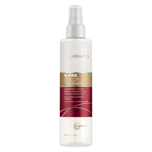 Een witte sprayfles met gouden, roze en witte labels, gemarkeerd 'Joico K-Pak Color Therapy Luster Lock Multi-Perfection.'
