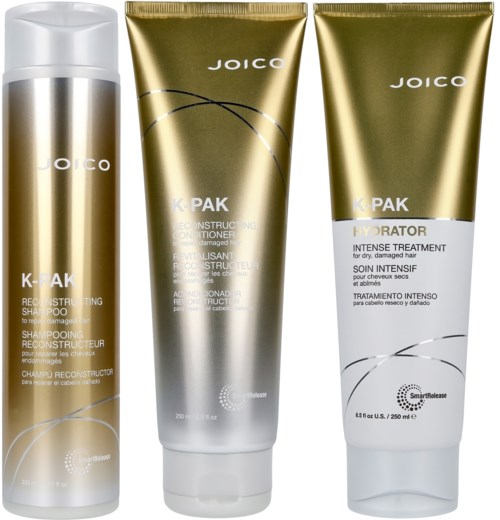 Three hair care products in gold and white packaging, including shampoo, conditioner, and treatment.
