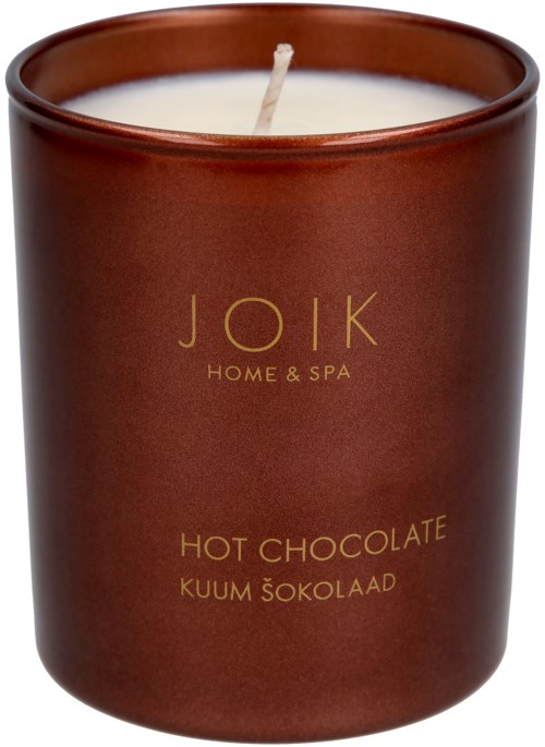 A brown jar candle with gold text saying "JÕIK HOME & SPA" and "HOT CHOCOLATE."