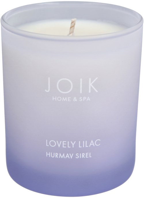 A white candle in a frosted jar with a faint purple tint. It has a single wick and minimal text on the front.
