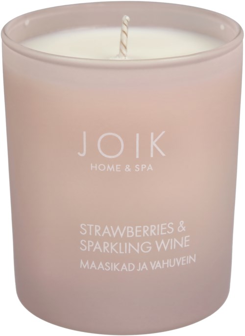 A pink candle labeled 'Joik Home & Spa' with scent 'Strawberries & Sparkling Wine' in English and Estonian.