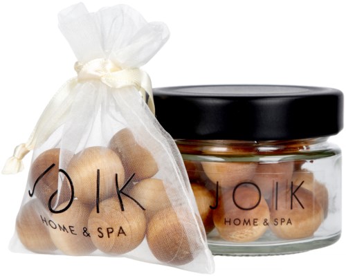 A jar and a bag of wooden balls from JOIK, a home and spa brand, with black and white packaging.