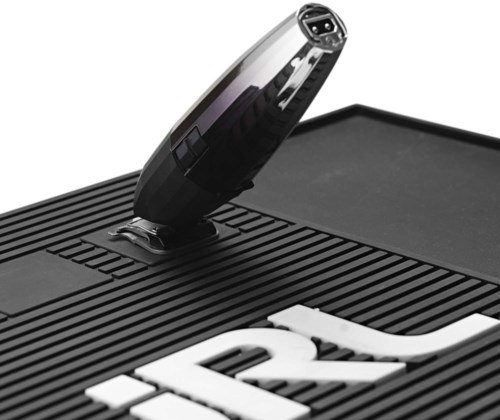 A black turntable with a stylus arm and part of a logo or text on its surface.