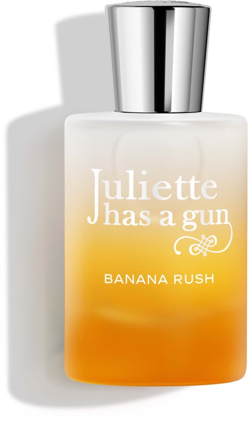 Een parfumfles met witte naar oranje verloop en zilveren dop. Tekst zegt Juliette has a gun Banana Rush.