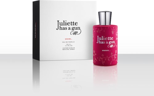 A perfume bottle with pink color and a silver cap, next to a white box, labeled "Juliette Has a Gun."