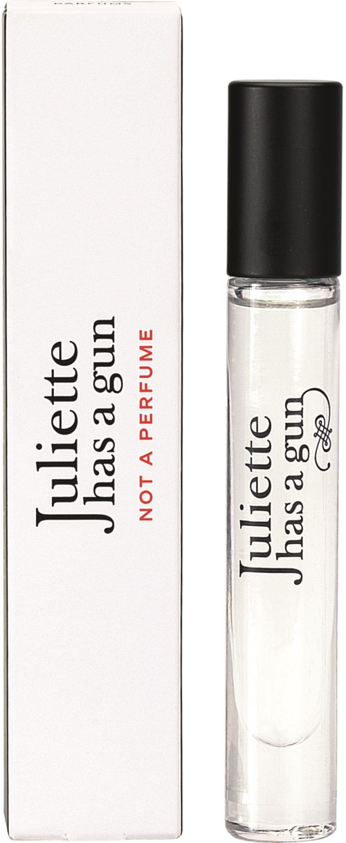 A perfume roll-on with white packaging, black cap, and black text, alongside a white box with similar branding.