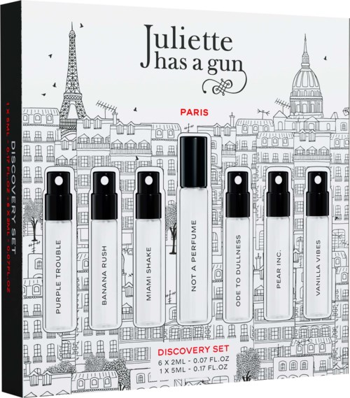 Seven small perfume bottles labeled Purple Trouble, Banana Rush, Mama Smash, Not a Perfume, Ode to Dullness, Pear Inc., Vanilla Vibes, with a larger central bottle. Background illustration of Paris landmarks.