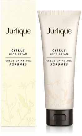 A beige tube and box of Jurlique Citrus Hand Cream with light fruit and flower designs.