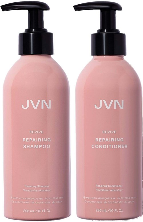 Zwei rosa Flaschen mit schwarzen Pumpen, gekennzeichnet mit 'REVIVE' für reparierenden Shampoo und Conditioner.