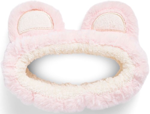 Soft pink fluffy headband with bear ears and stitched eye patches for skincare or makeup use.