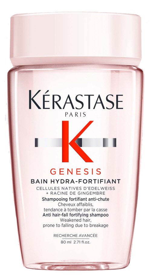 A pink bottle of Kérastase Genesis anti-hair fall shampoo with a white cap and label.