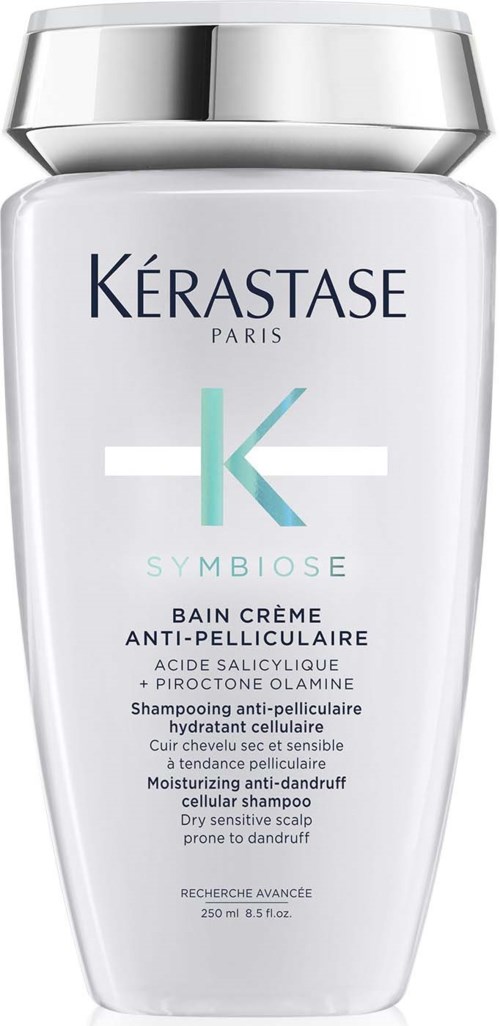 Een witte fles met een zilveren dop, gelabeld in blauw en groen, voor anti-roos shampoo.