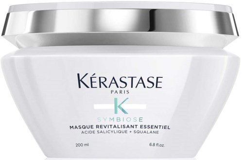 Een witte pot met zilveren deksel, gemerkt Kérastase Paris, bevat revitaliserend haarmasker met salicylzuur en squalaan.