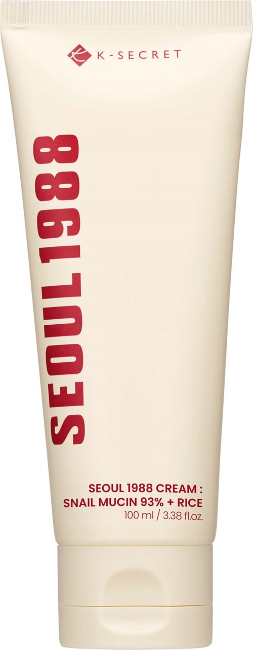 A white tube of K-Secret Seoul 1988 Cream with red text, featuring snail mucin and rice ingredients, 100 ml.