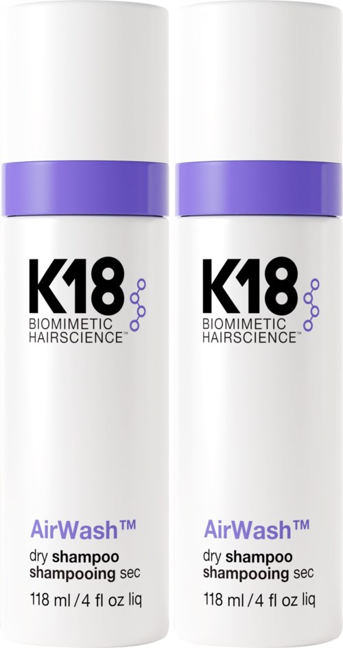 Two white bottles labeled K18 AirWash dry shampoo, with purple bands near the top.