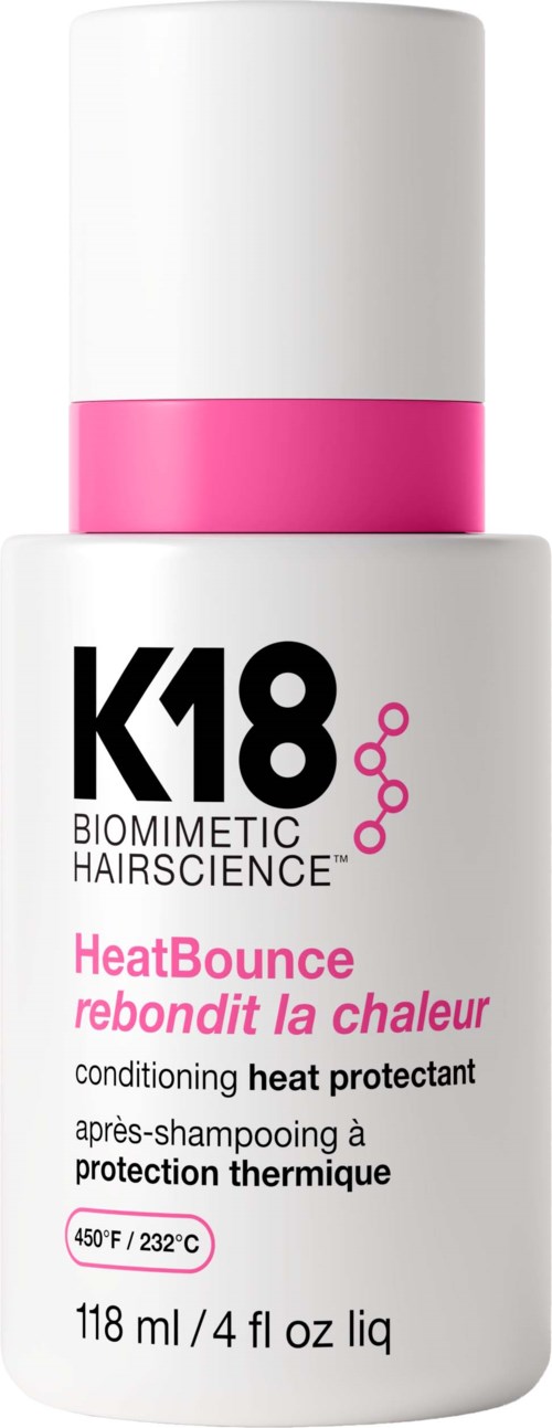 A white bottle with pink and black label for heat protection hair spray, labeled K18 HeatBounce, with temperature details.