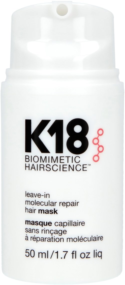 A white bottle of K18 biotechnic hair mask with black and red text, stating it is leave-in for hair repair.