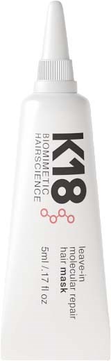 A white tube of K18 Hair Mask with a pointed applicator nozzle, labeled as leave-in for repairing damaged hair.