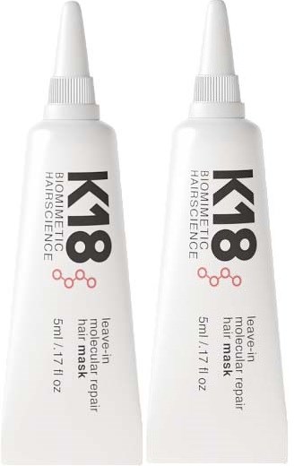 Two tubes of hair mask repair cream with white caps and black and pink text. Each tube is 50ml.