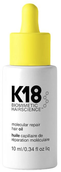 Small white bottle with yellow dropper cap, labeled K18 Biometric Hair Science, for molecular repair hair oil.