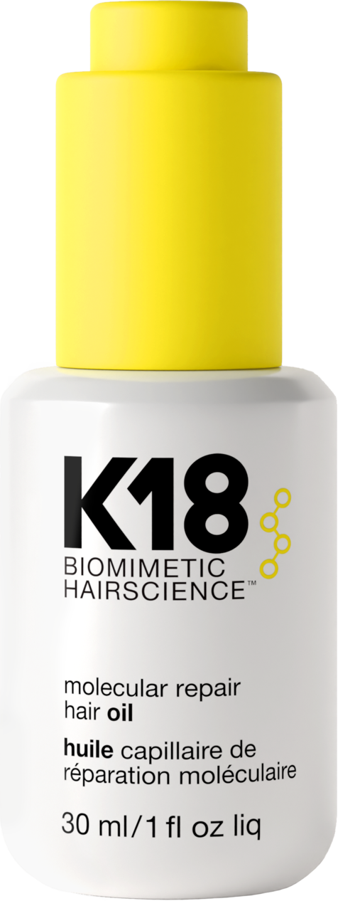 A white bottle with a yellow cap labeled K18 Biomimetic HairScience, for repairing hair, contains 30 ml of hair oil.