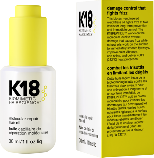 Hair oil bottle with a white and yellow label, and a black and yellow packaging box explaining benefits.