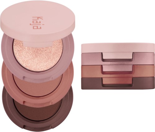 Ein Satz aus vier runden Make-up-Behältern gestapelt, in Rosa-, Braun- und Beigetönen, einer mit Glitzer.