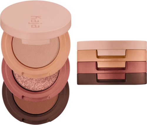 A stack of four round makeup containers with different shades, next to two additional containers with drawers.