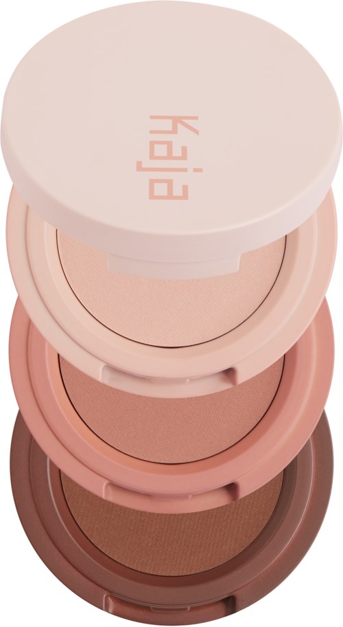 Gestapelde ronde make-up-huisjes in verschillende tinten roze en bruin. Bovenaan staat "PEACH".