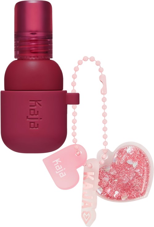 A pink bottle with a keychain and a heart-shaped charm with glitter attached.