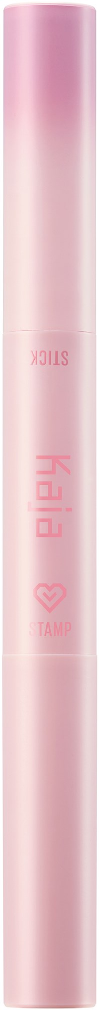 A pink cylindrical object, likely a cosmetic or skincare product, with text and a small heart symbol on it.