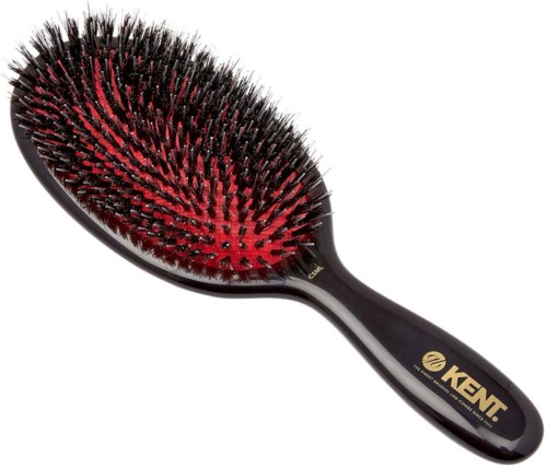 A hairbrush with black and red bristles. The handle is black with a gold logo and the word 'KENT' on it.