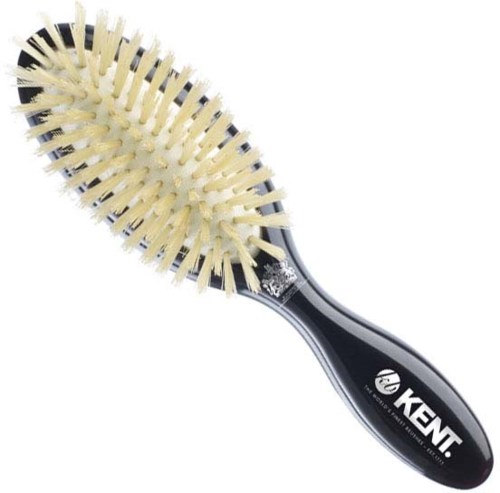A hairbrush with a black handle and many beige bristles for styling hair.