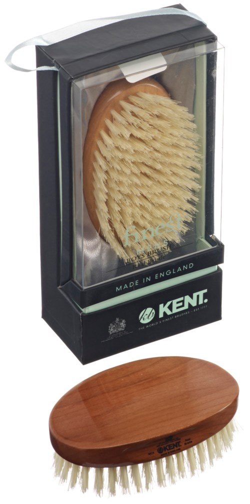 Eine Schuhbürste mit Holzgriff und eine transparente Box mit einer weiteren Bürste. Die Box hat einen Markennamen, Kent.