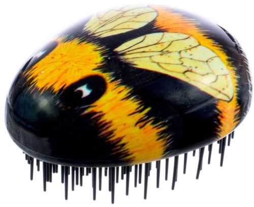 A grooming brush decorated like a bee with black and yellow colors and wing patterns. It has many small black bristles.