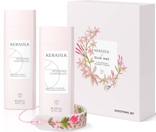 Kerastase Nourished and Controlled schampo och balsam i vita flaskor med rosa blommiga tillbehör, och en låda med blomsterdesign.