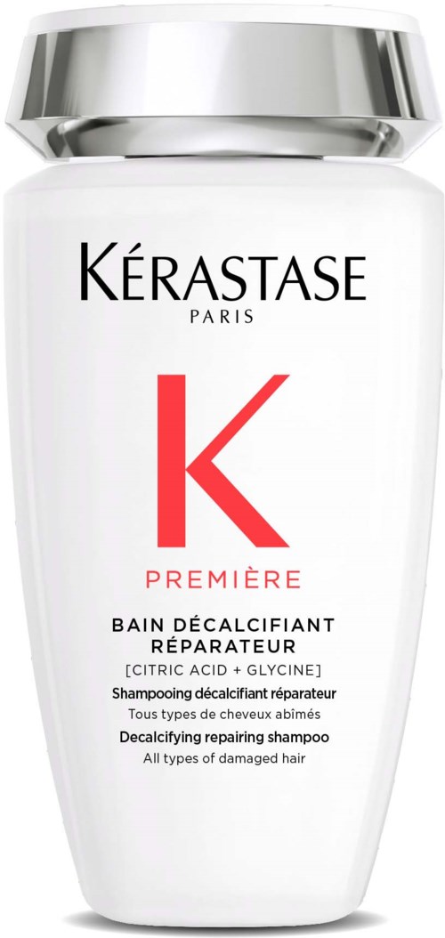 A white bottle with a silver cap, labeled 'Kérastase Paris' and 'Première' for damaged hair repair shampoo.