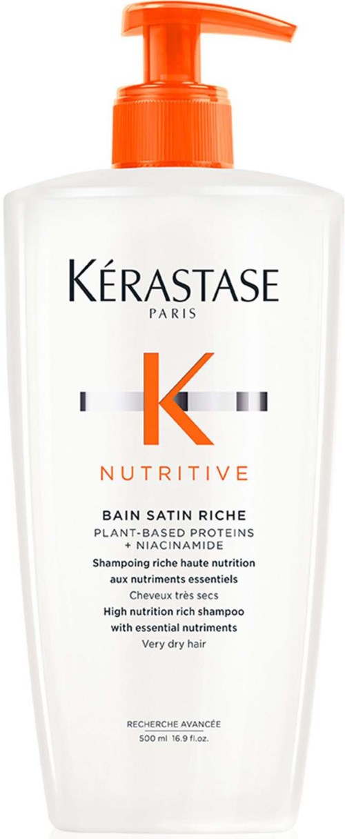 Een witte shampoo fles met een oranje pomp, gelabeld 'Kérastase Nutrive' voor zeer droog haar.