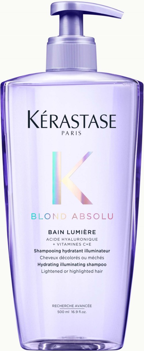 A tall, light purple bottle of hydrating shampoo with a pump, labeled Kerastase Blond Absolu Bain Lumière.