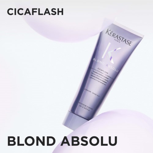 A tube of Kérastase Blond Absolu Cicaplashe hair treatment with white and purple design, on a light background.
