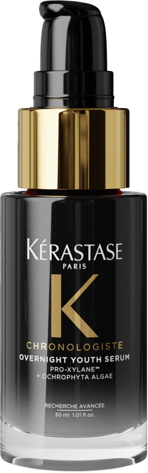 Een zwarte en gouden fles met Kérastase Paris serum met pomp voor haarverzorging.