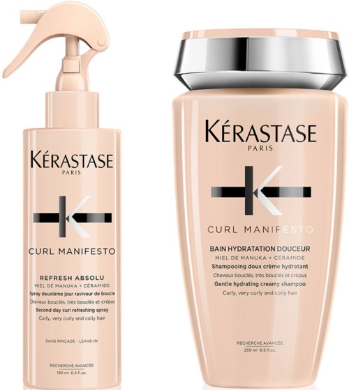Twee haarverzorgingsproducten van Kerastase, gemarkeerd 'Curl Manifesto,' met een sprayfles en een pot.