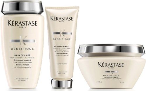 Drie haarverzorgingsproducten van Kérastase Densifique, inclusief shampoo, serum en masker in witte flessen met zilveren doppen.