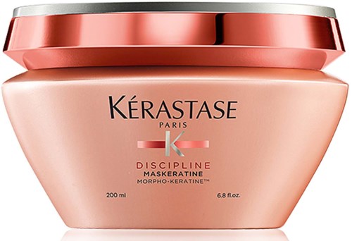 En rosa-orange burk med metalliclock, märkt Kérastase Discipline Maskeratine, för hårvård.