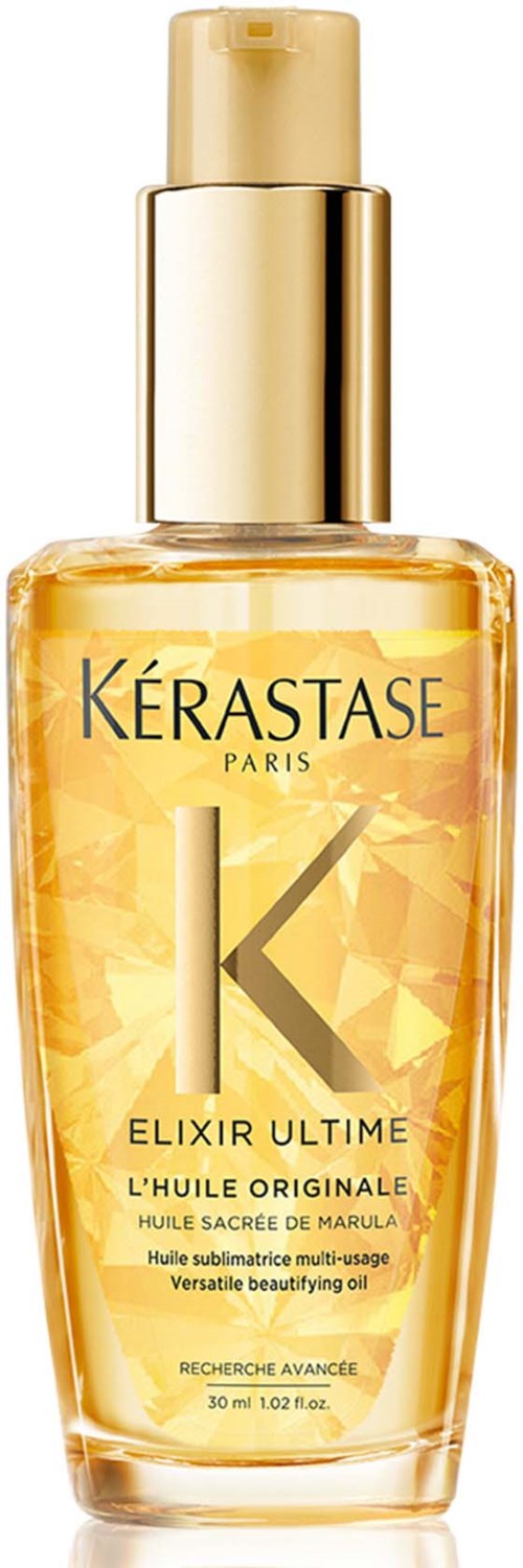 En tydlig flaska med hårolja med guldkork, märkt Kérastase Elixir Ultime, som innehåller guldfärgad olja.