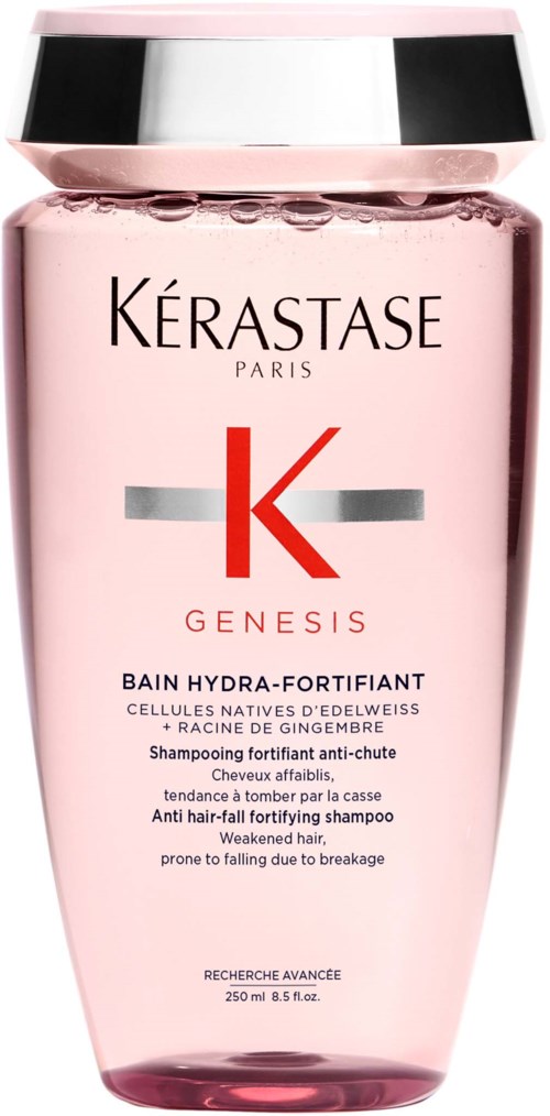 Pink shampoo bottle with silver and red label from Kérastase, designed for weak, fragile hair. It has a shiny metallic lid.