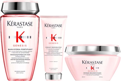 Drie roze en zilveren haarverzorgingsproducten uit de Kérastase Genesis lijn, inclusief shampoo, serum en masker.